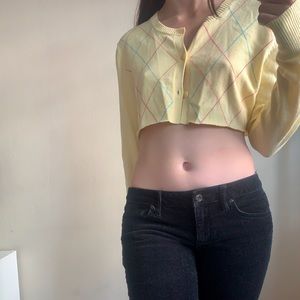 cropped yellow sweater and black corduroys